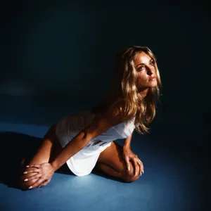 Sharon Tate Stretching On Floor Wallpaper