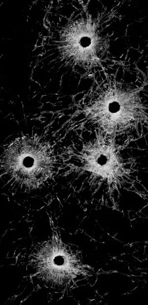 Shattered Screen Showing Multiple Bullet Impacts Wallpaper
