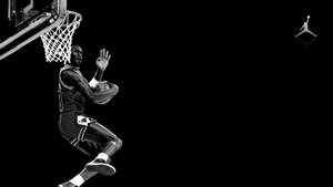 Shooting Michael Jordan With Jordan Logo Wallpaper