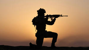 Silhouette Of A Soldier While Shooting Wallpaper