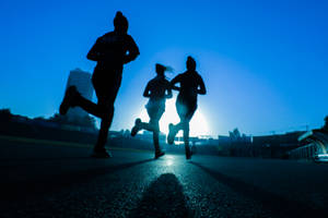 Silhouette Of Fitness Runners Wallpaper