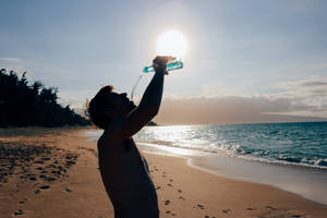 Silhouette Of Man Drinking Water Wallpaper