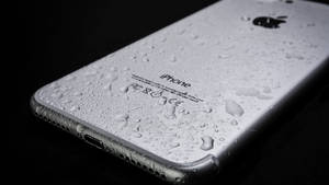 Silver Iphone Device In Black Wallpaper