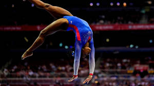 Simon Biles Performing Somersault Wallpaper