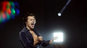 Singer Harry Styles Browsing His Laptop Wallpaper