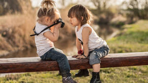 Sitting Children While Taking Photos Wallpaper