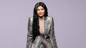 Sitting Kylie Jenner In Snakeskin Suit Wallpaper