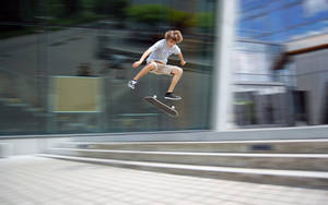 Skater Boy Flip Jump Pose Wallpaper