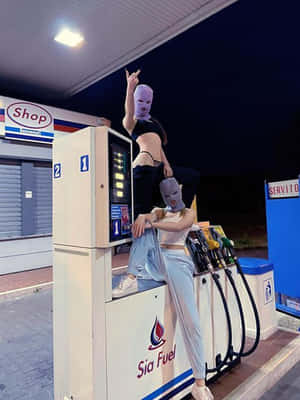 Ski Mask Girl Models Fuel Pump Wallpaper