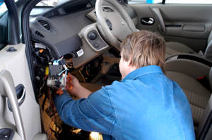 Skilled Electrician Repairing Vehicle Wiring Wallpaper