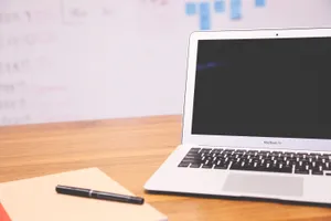 Sleek And Stylish Cute Laptop On Pink Background Wallpaper