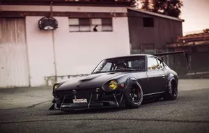 Sleek And Stylish Silver Datsun Captured On A Sunny Day Wallpaper