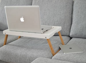 Sleek Apple Macbook Pro On A Wooden Surface Wallpaper
