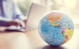 Small Globe Map On The Table Wallpaper