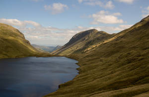 Small Lake Beside Hillside Wallpaper