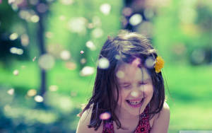 Smiling Child Confetti In Bokeh Effect Wallpaper