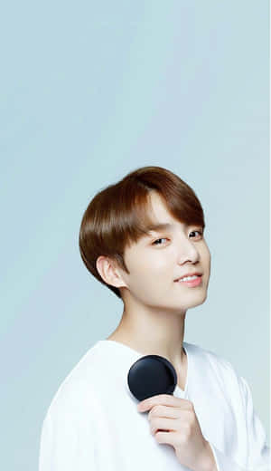 Smiling Young Man Holding Compact Mirror Wallpaper