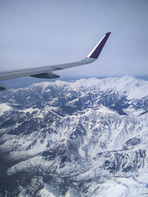 Snowy Mountains Scenery From A Plane Window Wallpaper