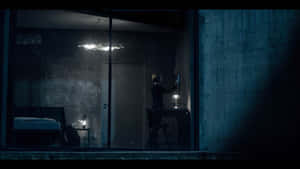 Solitary_ Figure_in_ Dimly_ Lit_ Room Wallpaper