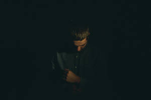 Solitude In Shadows - A Portrait Of A Sad Boy Wallpaper