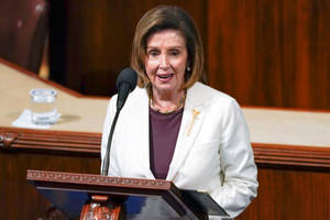 Speaker Nancy Pelosi Delivering A Speech On The Podium Wallpaper