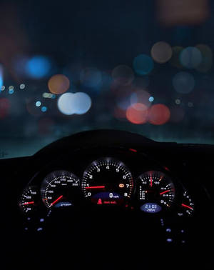 Speedtest Display On A Car Dashboard At Night Wallpaper