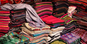 Stacks Of Clothes With Prints Wallpaper