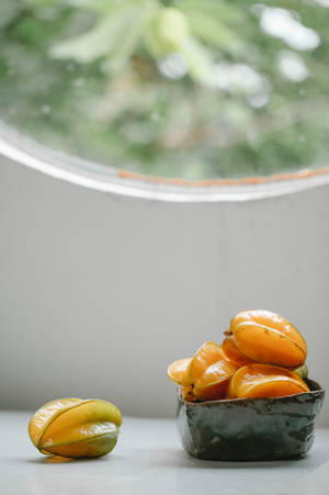 Star Fruit On White Table Wallpaper