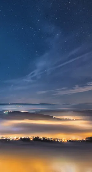 Starry Night Over Misty Landscape Wallpaper