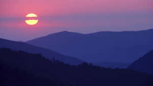 Start Fresh Everyday With A Beautiful Blue And Purple Sunset Wallpaper