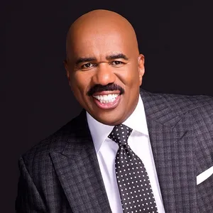 Steve Harvey Dazzles In A Checkered Suit Wallpaper