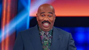 Steve Harvey Smiling In A Colorful Shirt Wallpaper