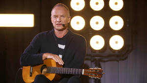 Sting Holding Guitar Wallpaper