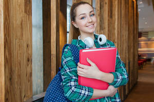 Student Studying At Cornell University With Headphones Wallpaper