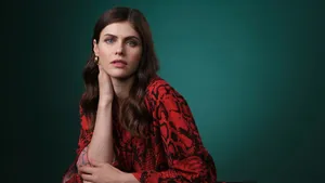 Stunning Actress Alexandra Daddario Wearing A Shiny Pink Dress Wallpaper