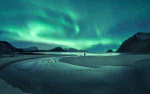 Stunning Aurora Borealis Dancing Across The Night Sky Wallpaper