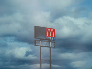 Stunning Cloud Aesthetic With Iconic Mcdonald's Signage Wallpaper