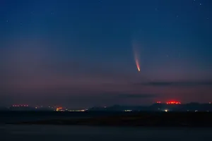 Stunning Cosmic Comet Illuminating The Night Sky Wallpaper