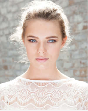 Stunning Indiana Evans Glowing In A Serene Setting Wallpaper