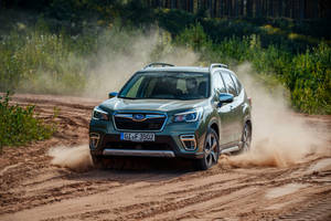 Subaru Forester Kicking Up Dust On Off-road Adventure Wallpaper