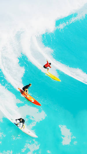 Surfing On Bright Blue Ocean Wallpaper