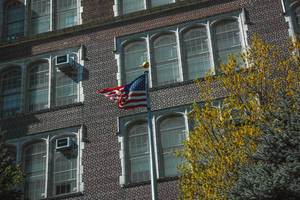 Tall Building With Usa Flag Iphone Wallpaper