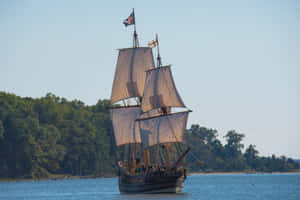 Tall_ Ship_ Sailing_on_ Calm_ Waters Wallpaper