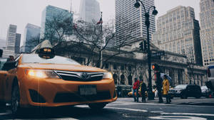 Taxi With Pedestrians Low Angle Wallpaper