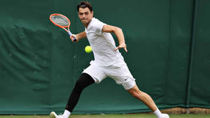 Taylor Fritz Performing Forehand Shot In Tennis Wallpaper