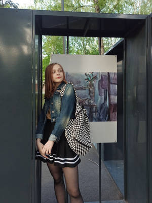 Teenage Girl Wearing A Denim Jacket And Skirt Wallpaper