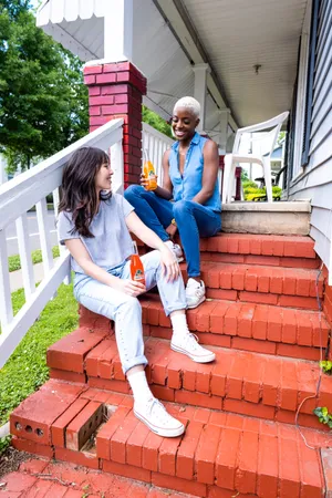 Teenage Girlfriends Outside House Wallpaper