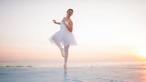 Tender Ballet Dancer Beach Pose Wallpaper