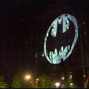 The Iconic Bat Signal Illuminating The Night Sky Wallpaper