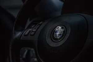 The Iconic Bmw Logo Against A Vibrant Blue Background Wallpaper